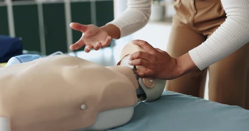 Person Practices CPR on Medical Mannequin