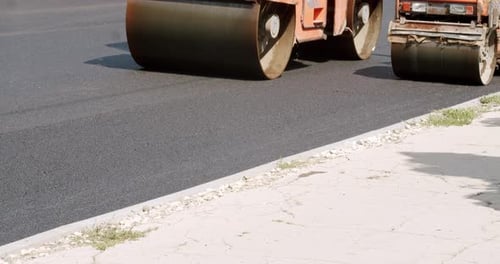 Asphalt Laying Road Building Asphalt Paver is Laying a New Layer of Asphalt
