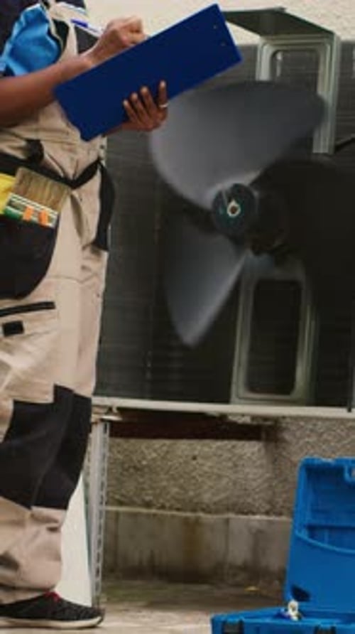 Vertical Video Electrician Servicing Air Conditioner