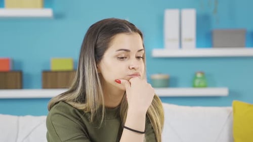 Thoughtful Woman Contemplates Indoors on Sunny Day