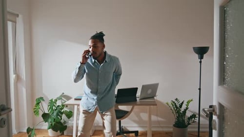 Angry Guy Talking Smartphone Home Office. Nervous Professional Speaking Cellphone at Workplace