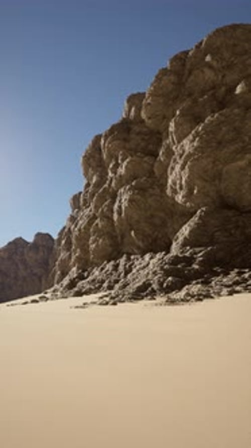Majestic Rock Formation Overlooks Sandy Beach