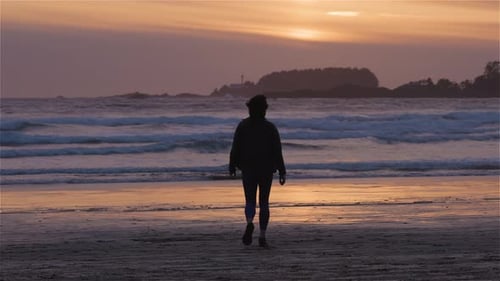 Adventurous Woman Standing on the Sandy Beach on the West Coast of Pacific Ocean