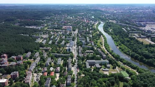 AERIAL: City View from Very High Altitude with Visible River and Buildings on the Surface
