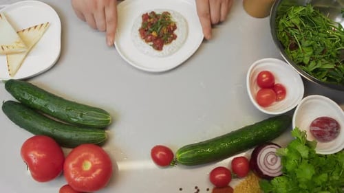 Serving Gourmet Restaurant Dishes of High Cuisine Fresh Vegetables and Herbs are on the Kitchen