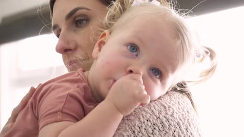 Close Up Mother Holding Cute Tired Toddler Daughter Sucking Thumb Slow Motion