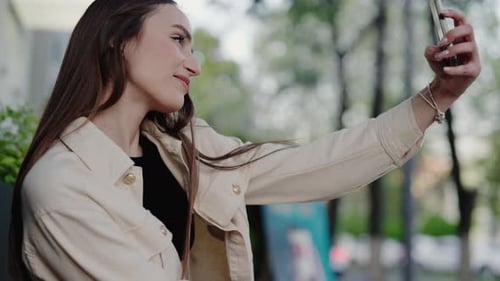 Young Woman Taking A Selfie Outdoors In A Park On A Sunny Day
