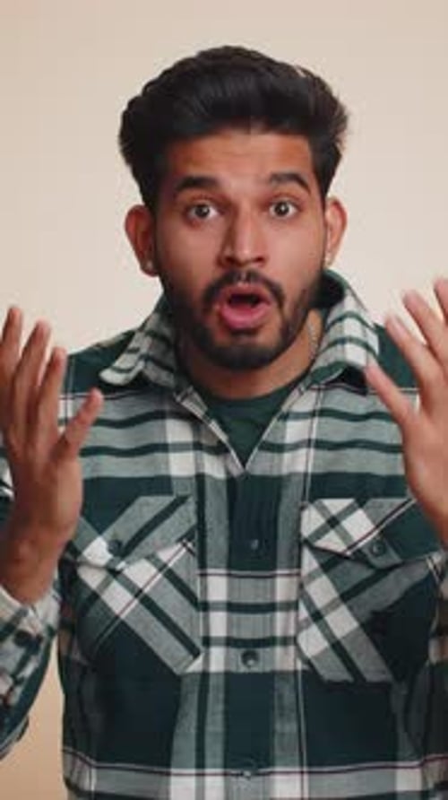 Astonished Young Man Reacting to News, Indoor Studio Shot