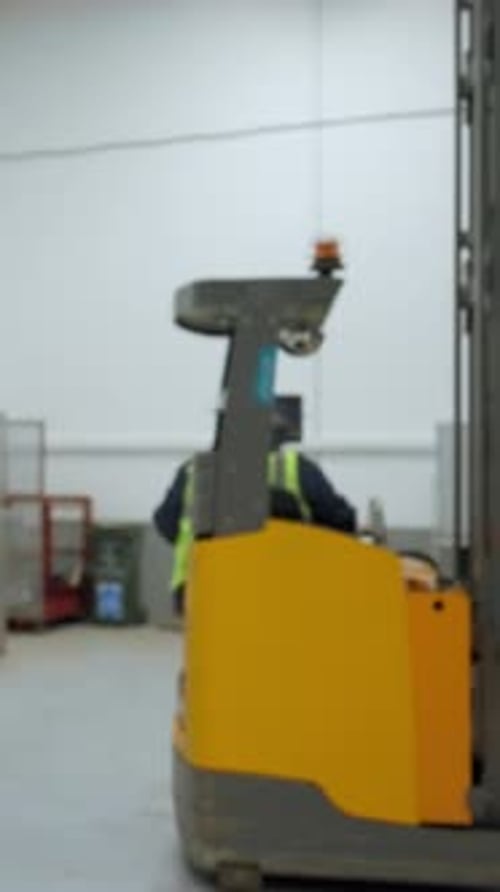 Vertical of Engineer Controls Machinery Equipment in Modern Warehouse
