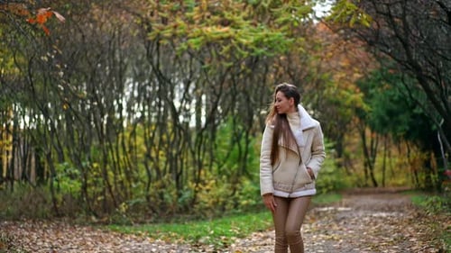 Woman Walking in Autumn Park Landscape