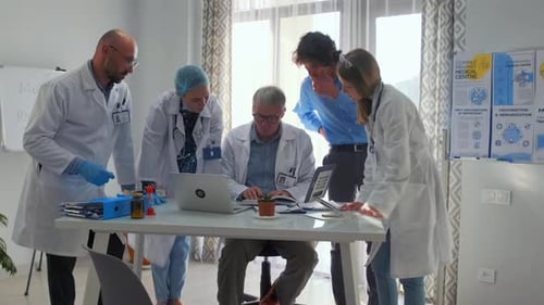 Team of Doctors Analyzing Research in Hospital Meeting