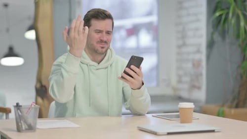 Frustrated Man Reacting to Smartphone Problem