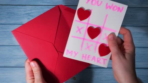 Valentine's Day Card Placed into Red Envelope