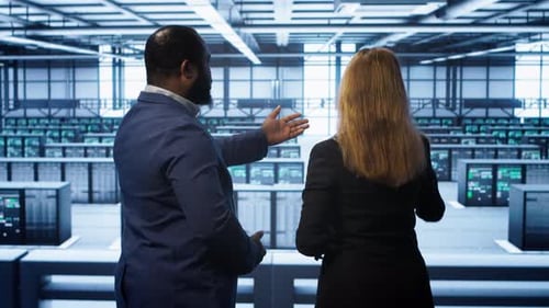 Data Center Engineer Presenting Equipment to Inspector Supervising Operations