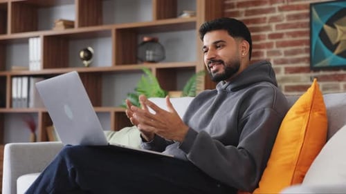 Man on Video Call at Home on Laptop