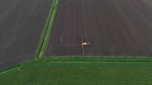 Tractor Spraying On Field With Sprayer, Herbicides And Pesticides