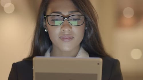 Young Woman Using Tablet Computer at Workplace
