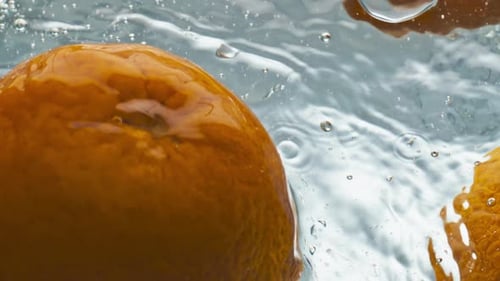 Tasty Oranges Splashing Water Closeup. Delicious Juicy Fruits Floating Bubbling Liquid Top