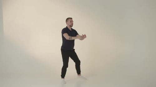 Young Man Doing Squats and Lunges in Studio