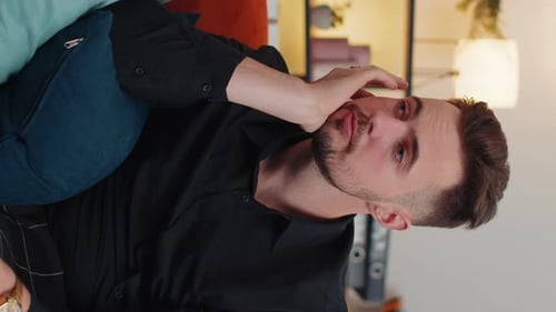 Man On Couch With Hand On Face