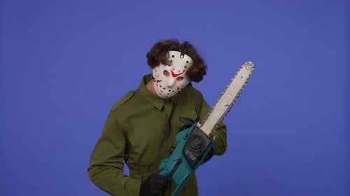 Man in White Mask with Chainsaw in Hands on Blue Background Image of Maniac Jason Voorhees From