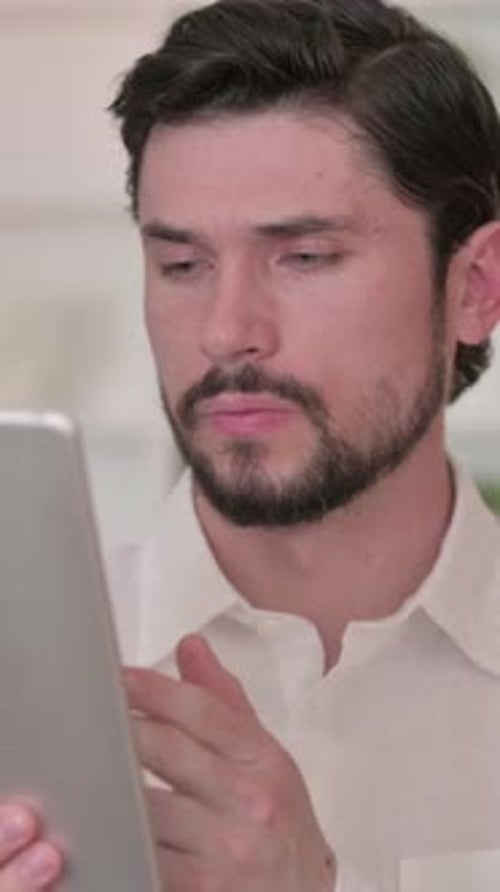 Young Man Using Tablet, vertical video