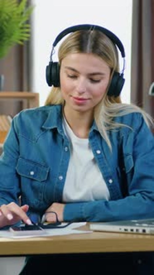 Smiling Woman Listening to Music with Headphones