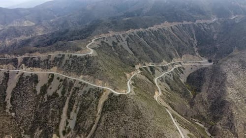 Serpentine road drops by switchbacks off mountain pass in Argentina