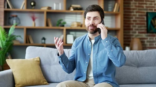 Man Talking on Mobile Phone on Couch