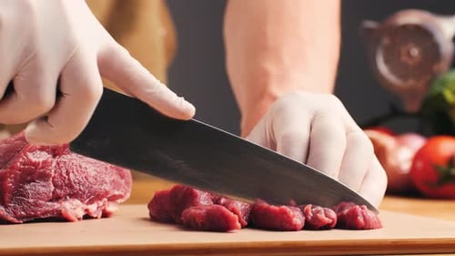 Meat Being Cut on a Cutting Board