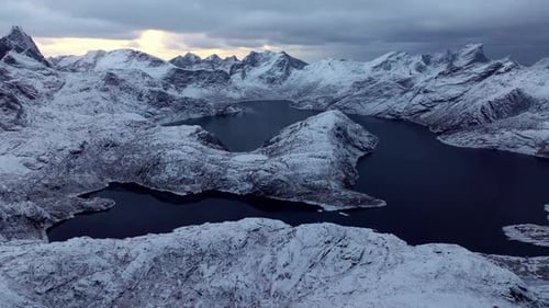 A Breathtaking Aerial Panorama Captures Snowcapped Rocky Mountains in the Grip of Fierce Winds