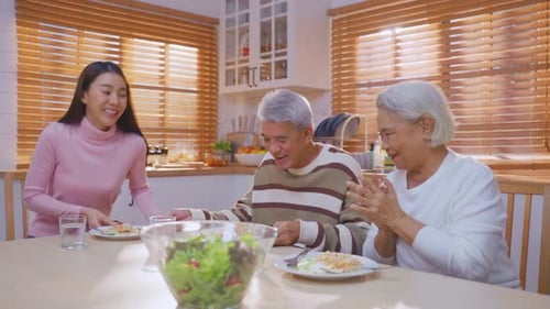 Woman Serves Senior Couple Lunch at Home