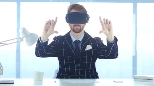 Redhead Man Wearing Virtual Reality Glasses in Office