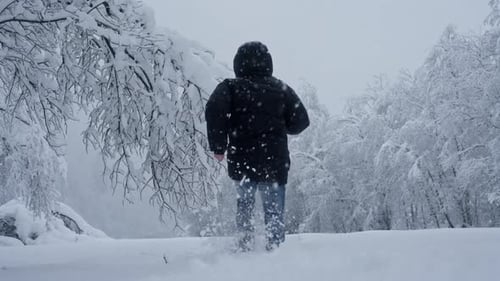 Man Sprints Through Snowy Landscape