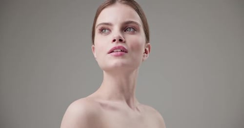 Auburn Haired Woman Posing in a Studio