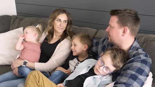 Family Relaxing Together on a Comfortable Gray Sofa