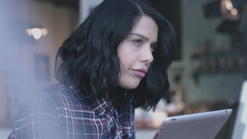 Woman Using Tablet and Drinking Coffee Indoors