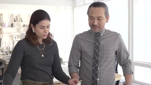 Colleagues Reviewing Documents in Bright Office Setting