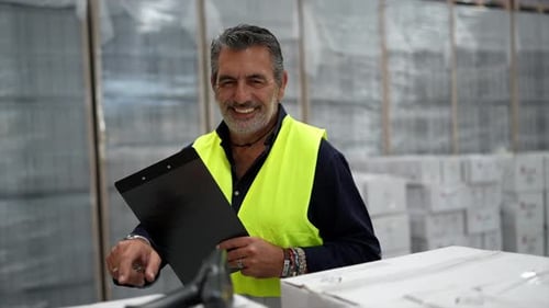 Warehouse Worker Managing Inventory and Checking Stock