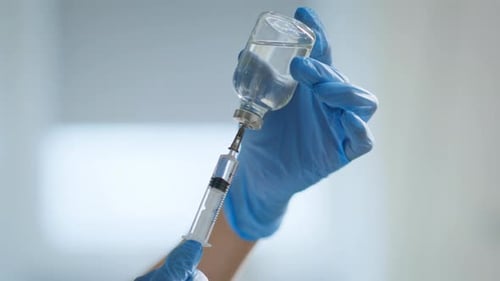 Nurse Hands Preparing Vaccine Dose for Injection Closeup Doctor Filling Syringe