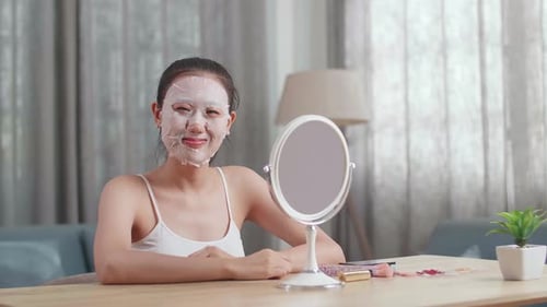 Woman Wearing Facial Mask Smiles in Home Setting