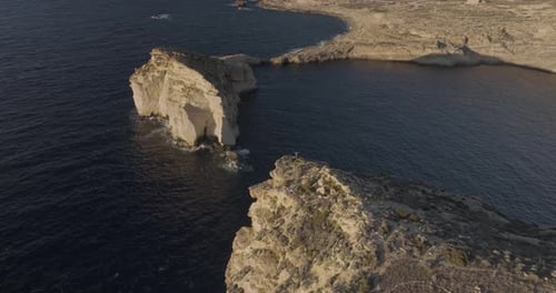 Aerial view of rugged Gozo cliffs and Dwejra Bay, Munxar, Malta.