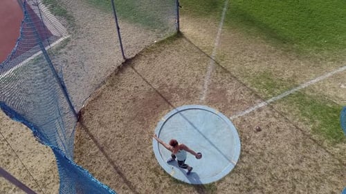Woman Discus Thrower Training in Field Aerial Shot