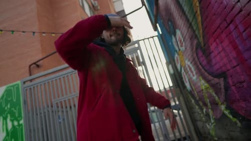 Street Dancer Dances a Modern Hip Hop Dance in a Red Jacket