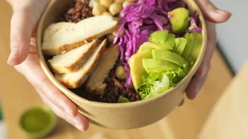 Person Holds Healthy Salad Bowl Close Up