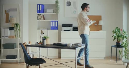 Contemplative Businessman Thinking By Window In Office