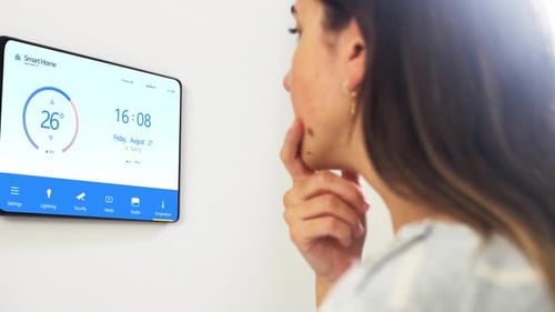 Woman Using Smart Home System On Wall
