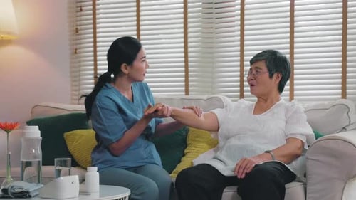 nurse provides physical therapy to the elderly at a nursing home