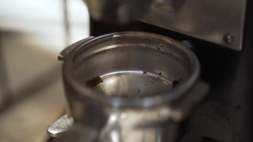 Getting espresso grounds from a coffee grinder. This was taken at a higher frame rate and has been c