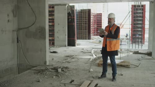 Middle-Aged Engineer at Construction Site